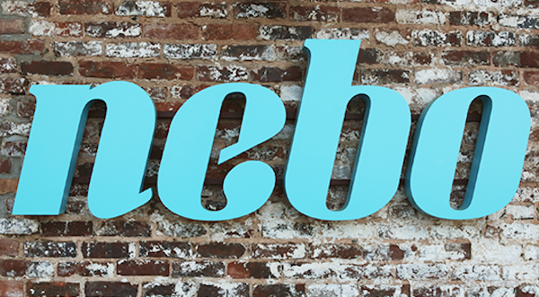 Nebo Sign Against Brick