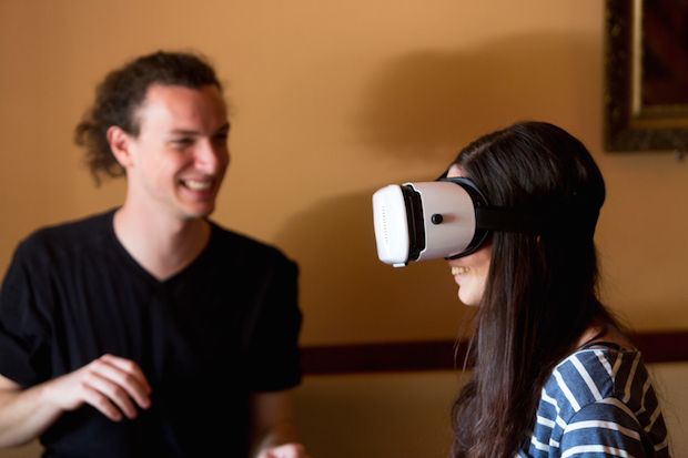 Virtual reality game: girl using head mounted display oculus rift