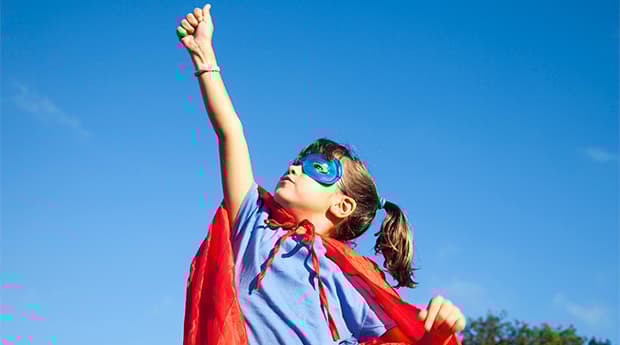 Little seven years old girl with a handmade superhero disguise.